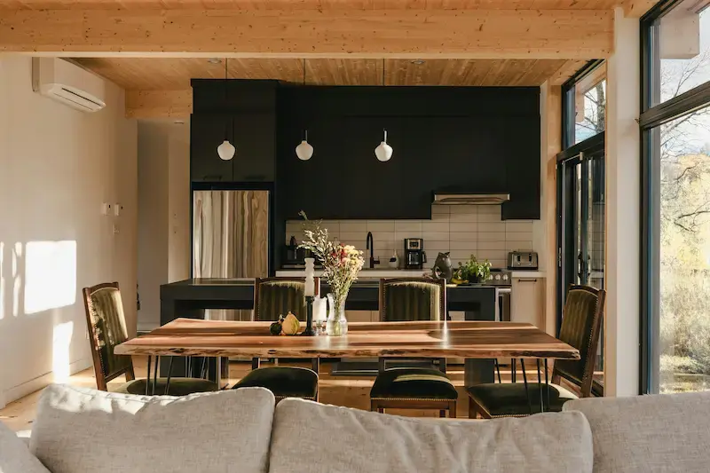 Open floor plan lighting hierarchy  pendant kitchen zone and ambient living zone 2026