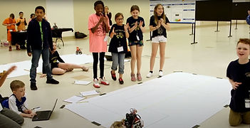 Students celebrating robots