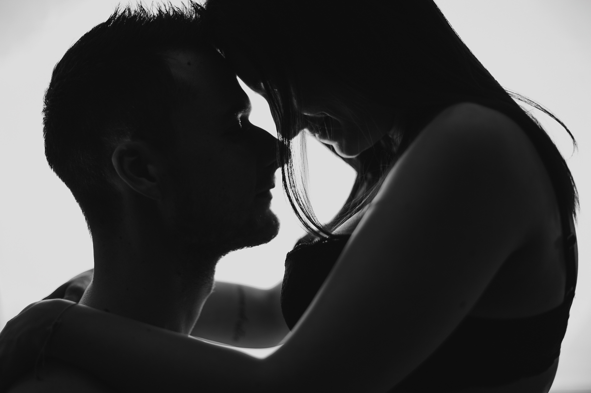 Romantic silhouette of a couple embracing at sunset