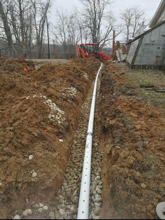 French drain installation in progress with trench and drainage system being constructed in Martinsville, Indiana.