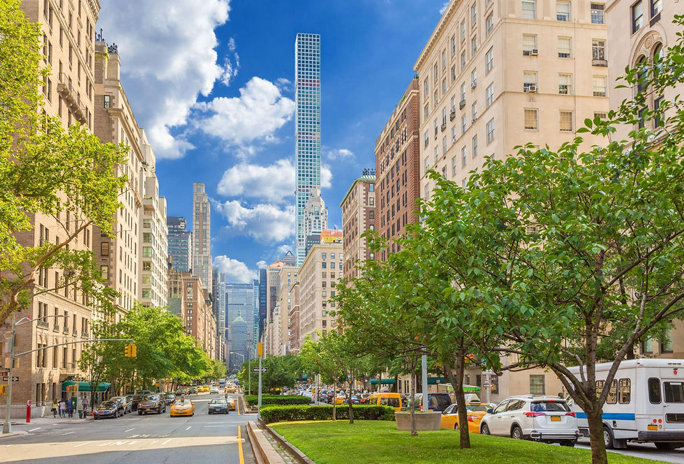 Midtown Manhattan residential street with the 432 Park Avenue tower rising behind leafy buildings