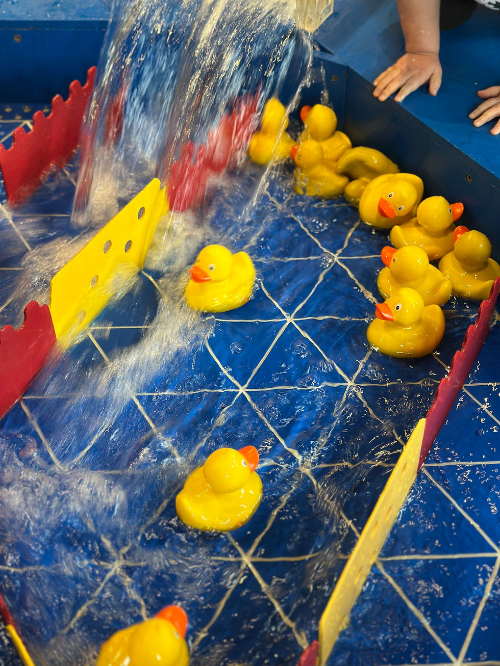Yellow rubber ducks scattered by water stream, symbolizing perfectionism disrupted — Healthy Made Easy blog on embracing imperfection.