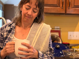 Woman resting reflectively after doing dishes