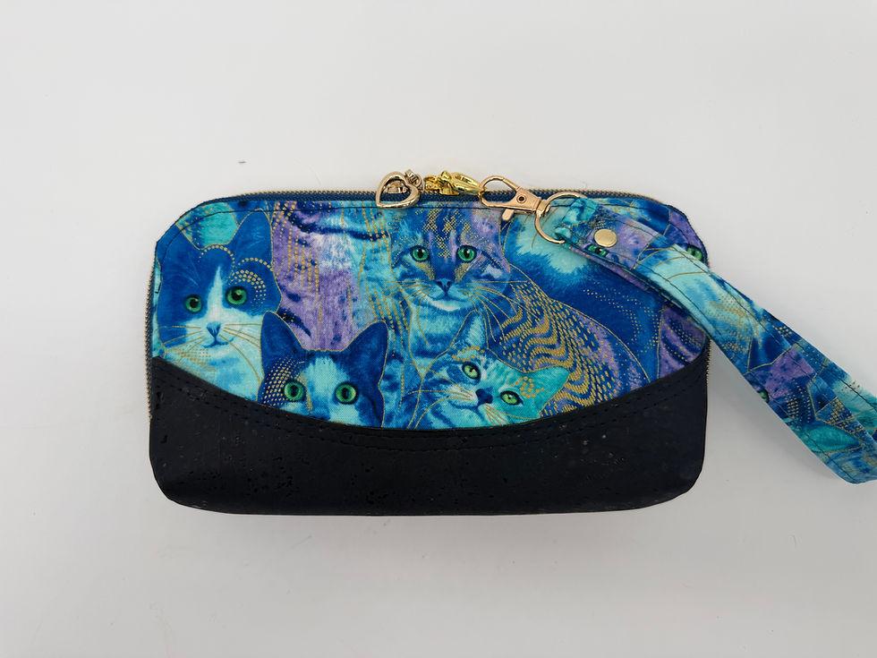 Outside of adorable clutch/wallet with cat design cotton trimmed in navy blue cork. The wrist strap is detachable.