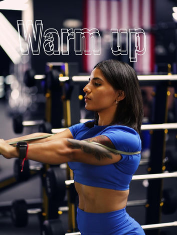 Warm up. Woman stretching with band in gym. | Alpha Gym Fitness | Orlando, Fl