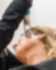 a person wearing goggles and looking at a microscope