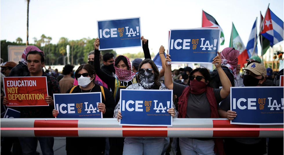 CNN Reports | Protesters hold placards as they gather around the Los Angeles Federal Building following multiple detentions by Immigration and Customs Enforcement, in downtown Los Angeles on Friday. Daniel Cole/Reuters