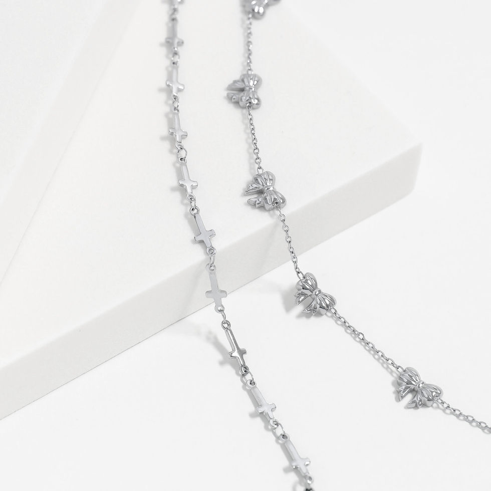 Polished Stainless Steel Cross Station Bracelet displayed beside a Polished Stainless Steel Bow Station Bracelet