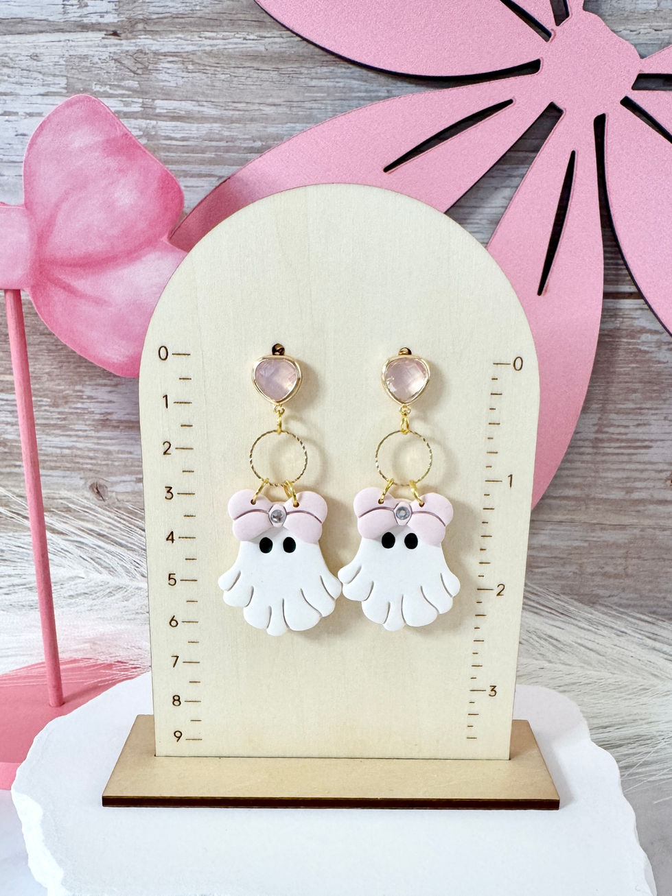 Boo-La-La Handmade Polymer Clay Earrings - Ghost with pink bow and a pink glass stud on ruler board