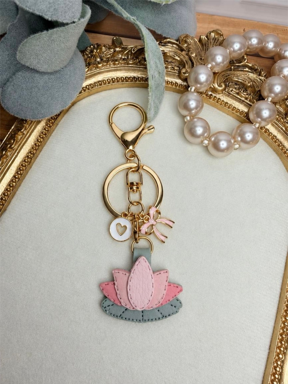 Handmade polymer clay Lotus Bloom key ring - bag charm with gold hardware and charms.