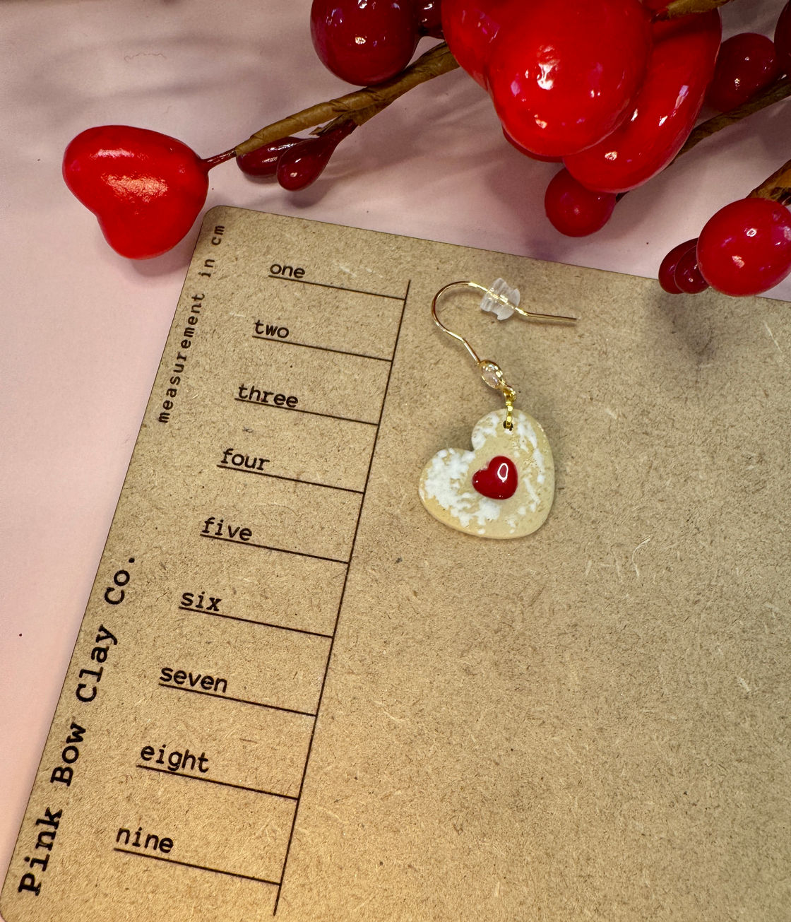 White powdered jelly heart earring with a red heart center