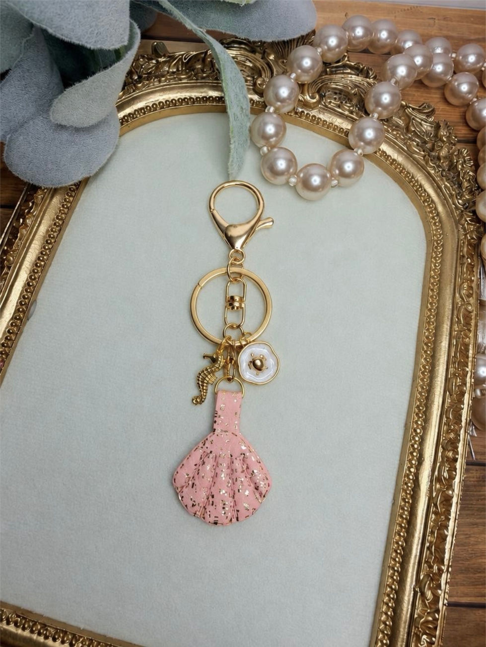Handmade Seaside clay key ring with pink seashell, gold-tone hardware, and coordinating coastal accent charms.