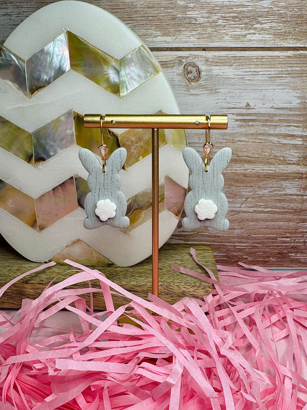 Gray polymer clay bunny earrings with white cotton tails and gold CZ pavé hooks.