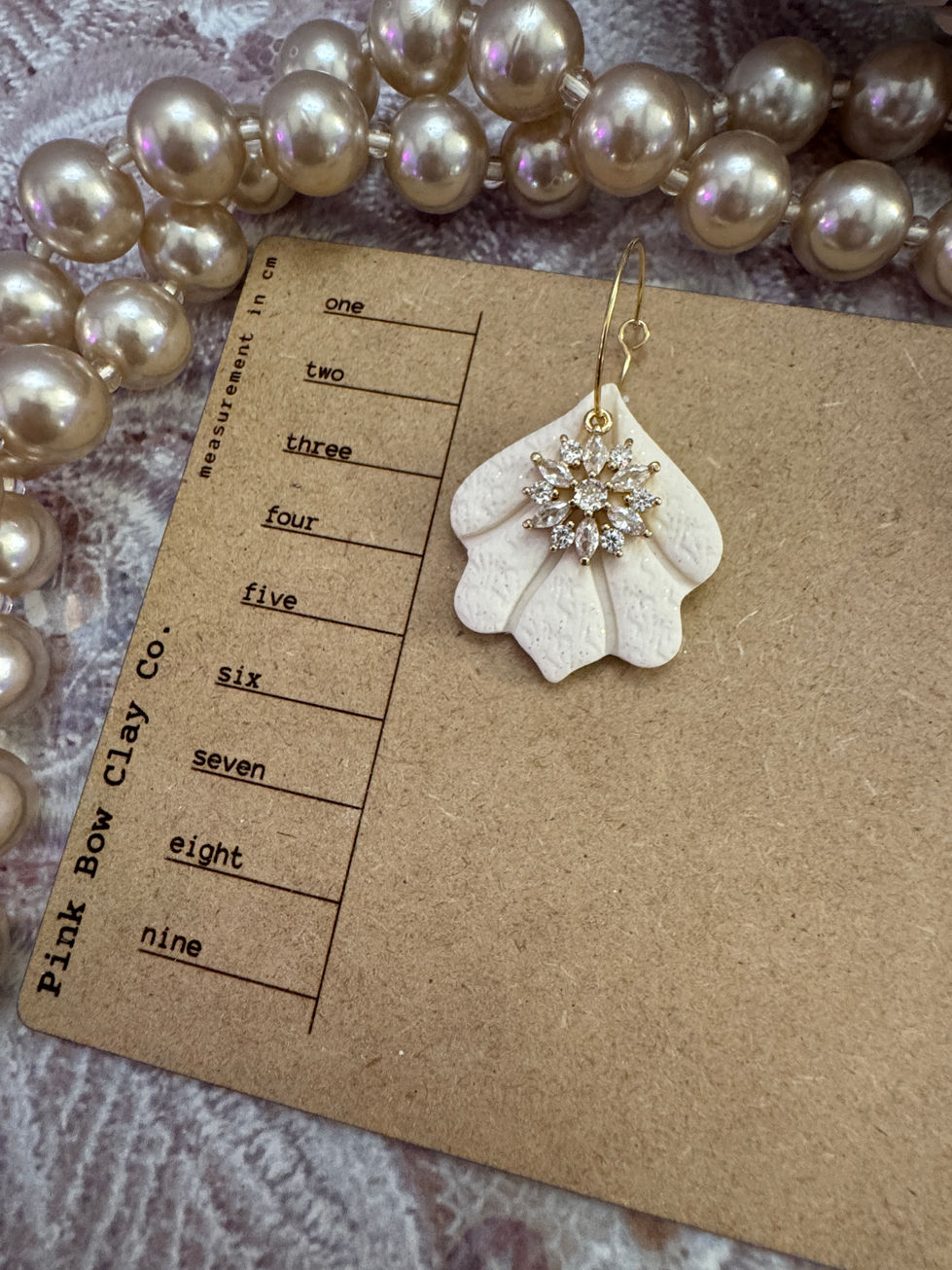 Pink Bow Clay Co. shell earring with crystal flower