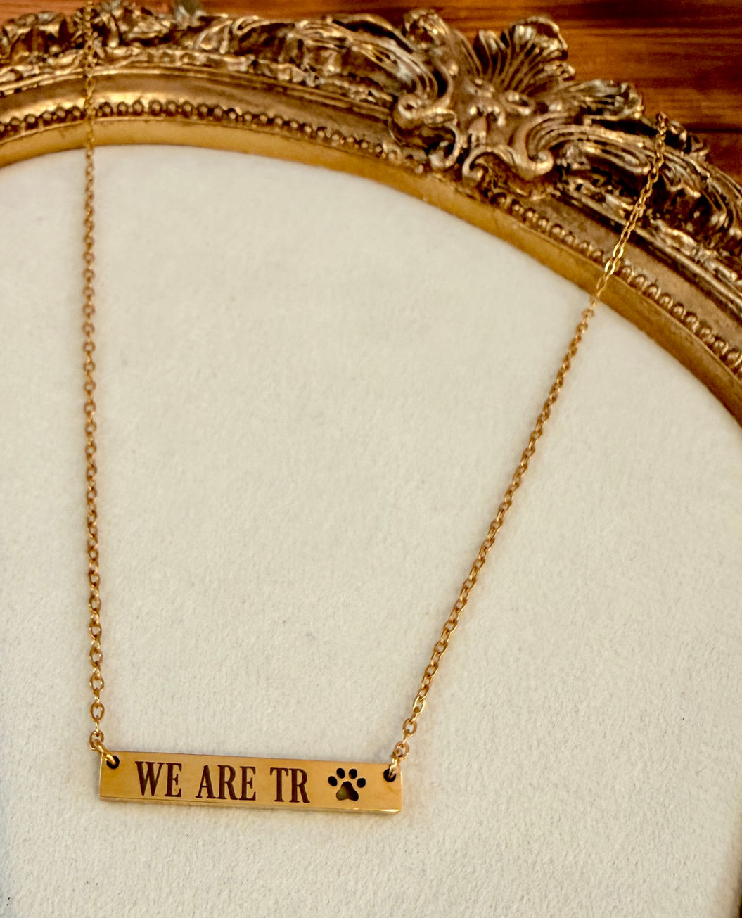 WE ARE TR Cutout Pawprint Bar Necklace shown in 18K Gold PVD Plated 316L Surgical Stainless Steel right orientation