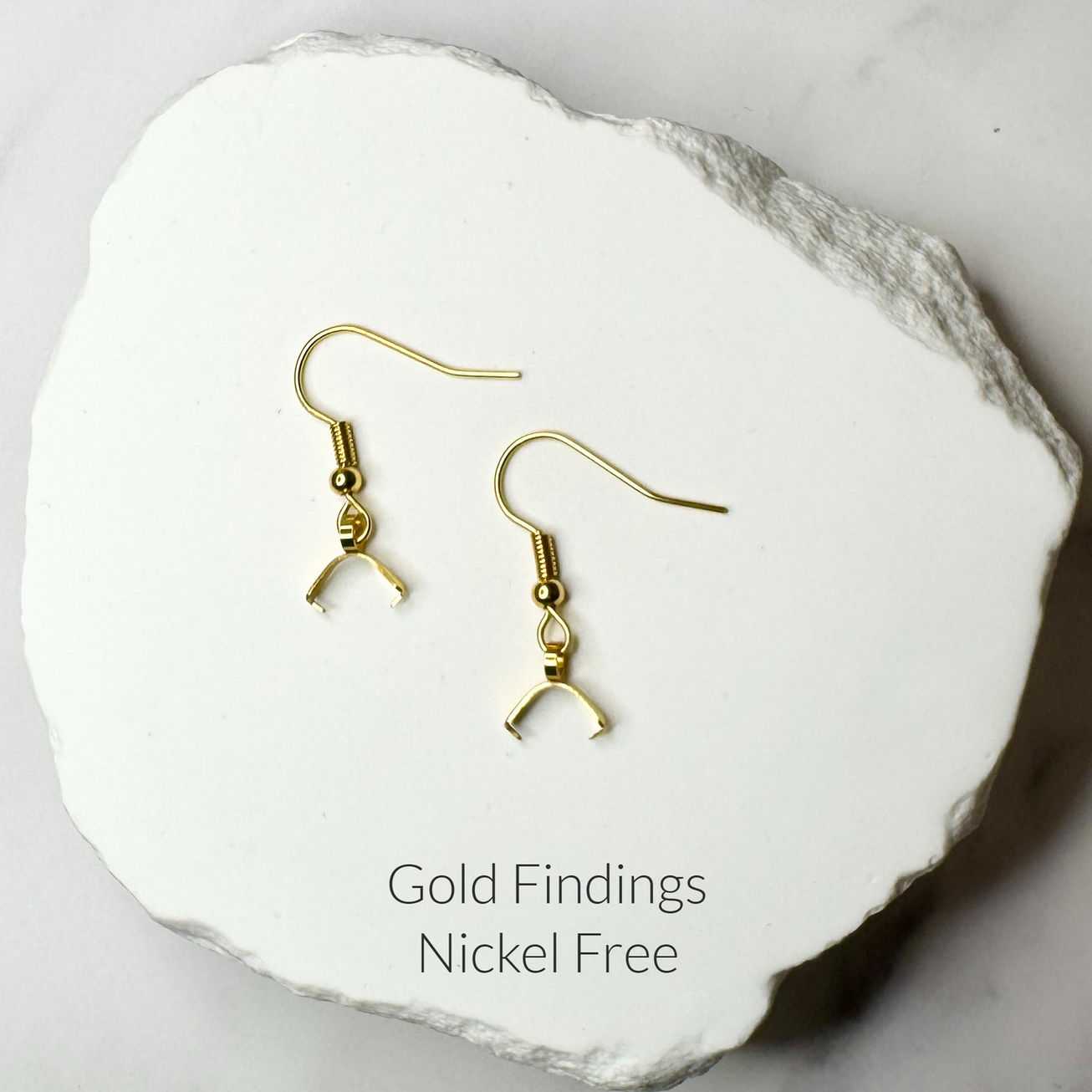 gold-tone fishhook ear wires displayed on white stone