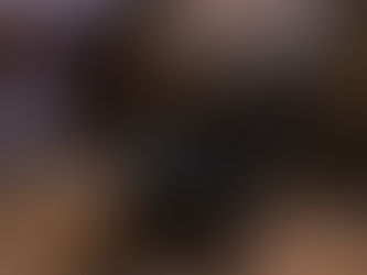 Small glazed pottery bowl sits on sand covered surface surrounded by broken pottery shards and larger vessels in the distance.