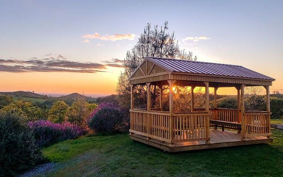 Outdoor cabana pavilion used as a relaxing backyard leisure space with open seating and Texas sunset views