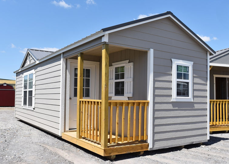 12x36 Derksen Side Cabin with corner porch featuring upgraded LP SmartSide Lap Siding and Sunburst Dormer.  Great size for one bedroom studio apartment tiny home.