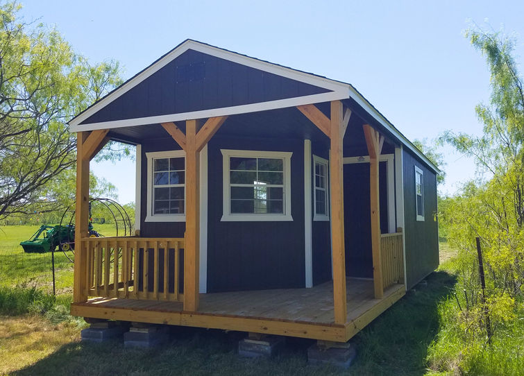 12x34 Derksen Deluxe Cabin in Midnight Blue with white trim.