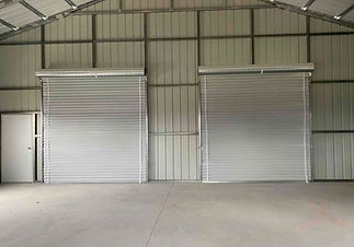View of roll up doors from inside of building.