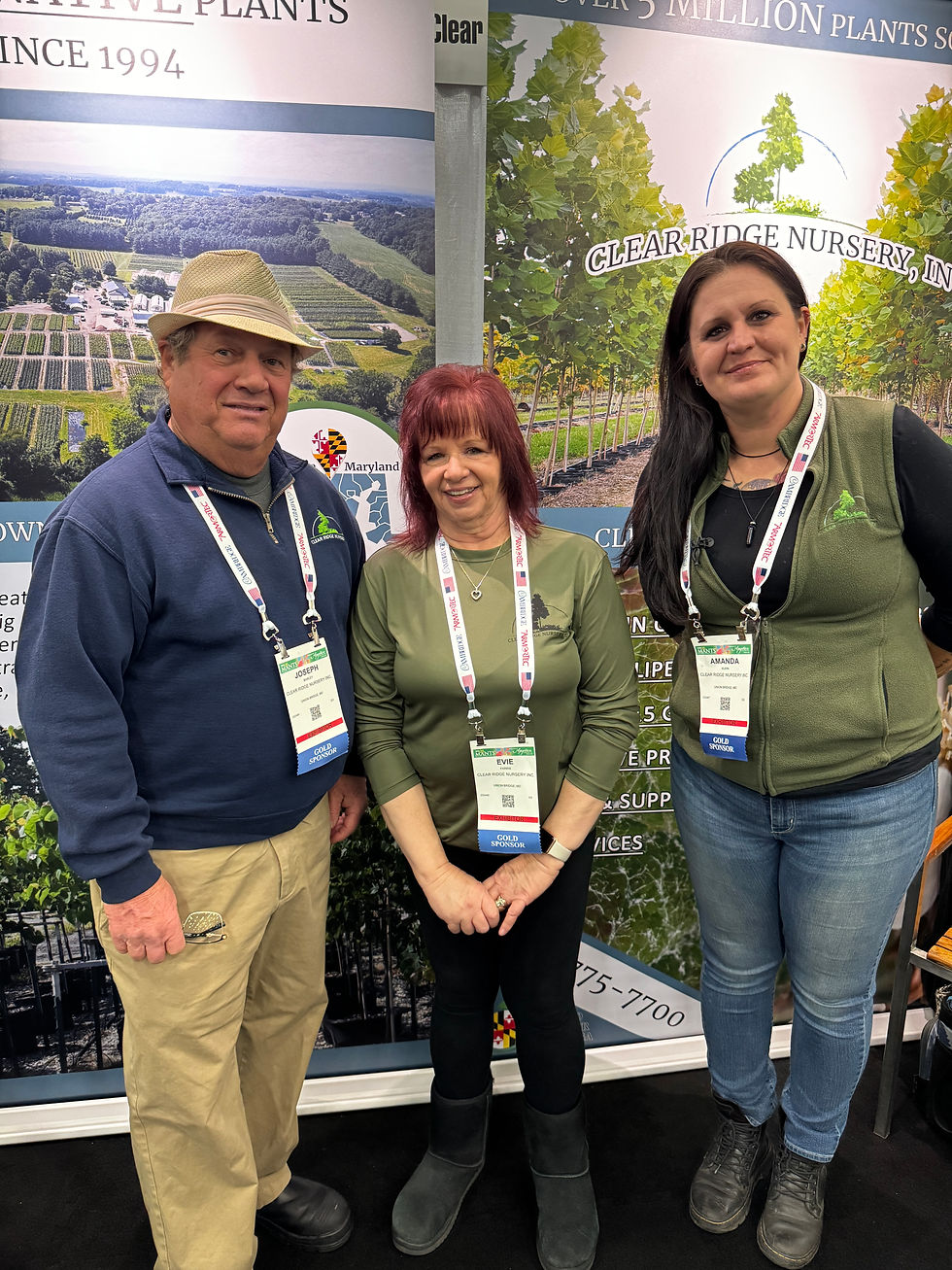 three people in fornt of farm display