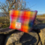 Small handmade Harris Tweed® pouch in rainbow check, crafted in Scotland with cotton lining and YKK zip – compact, colourful,