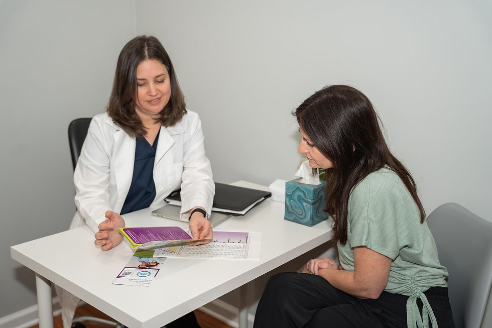 Celisha Gerber, ND, LAc of NDCARE, INC. showing a brochure to a client.