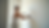 Eye-level view of a painter applying primer on a wall