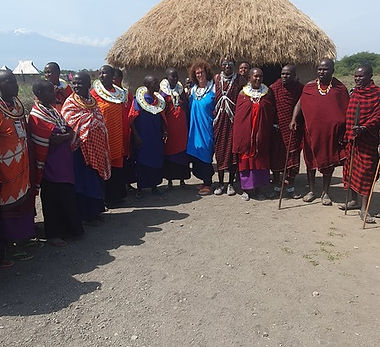 woman tourist standing with masai tribe