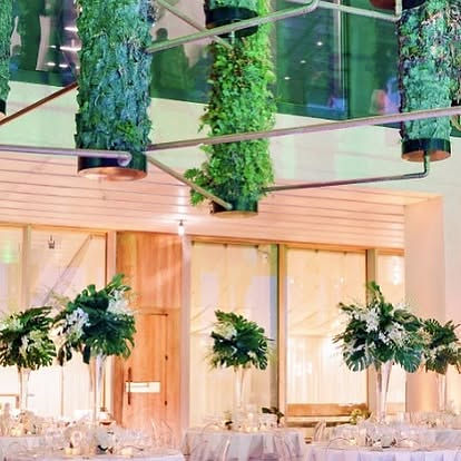 Event space with hanging plants and floral table decor