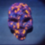 High angle view of Yooperlite specimens glowing in the dark