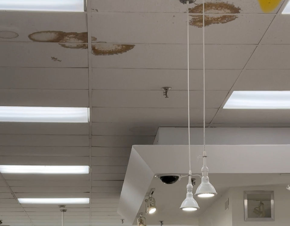 Brown stained drop ceiling tiles of a department store
