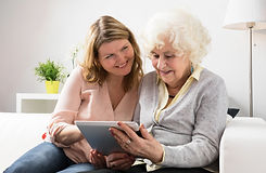 mother and daugther looking at iPad