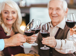 Palisade Gardens Full Service Retirement living - friends celebrating with red wine