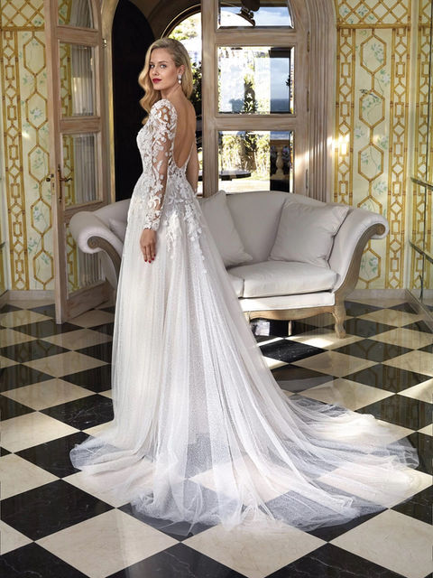 A blend of sparkle tulle and intricate beaded lace. Long embellished illusion sleeves highlight the seductive v-neckline and low back. A sexy thigh high slit on the shimmering A-line skirt adds a sensual appeal.