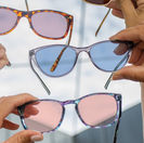 People holding colored lens glasses