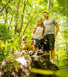 The founders of The Monster Minders with their dogs in a park near Philadelphia