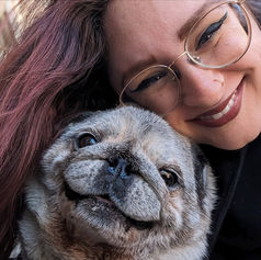 A dog walker takes a selfie with a very old pug