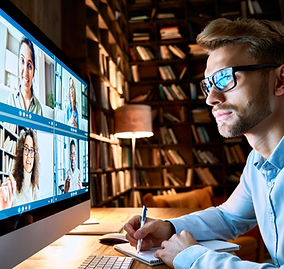 Image shows a young man taking notes whilst on a Zoom Meeting - OutSec Legal Note Taking and Minuting Service