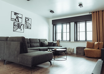Luxurious living room at Arrivée, featuring elegant decor, comfortable seating, and sophisticated ambiance.