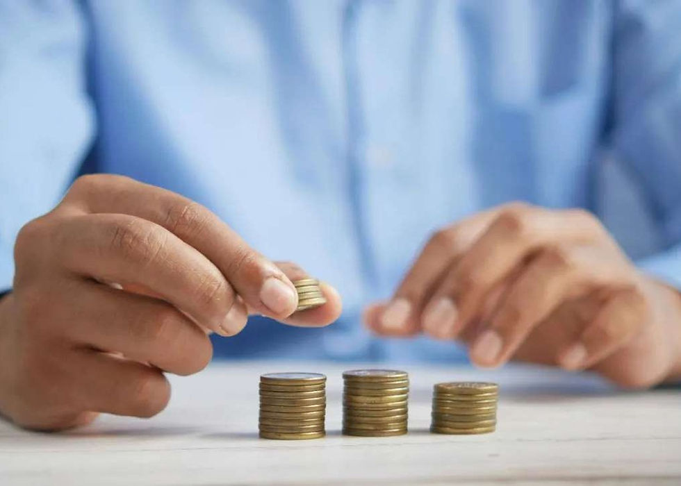Hands stacking coins, representing the different kinds of foreign income that can arise from overseas assets.