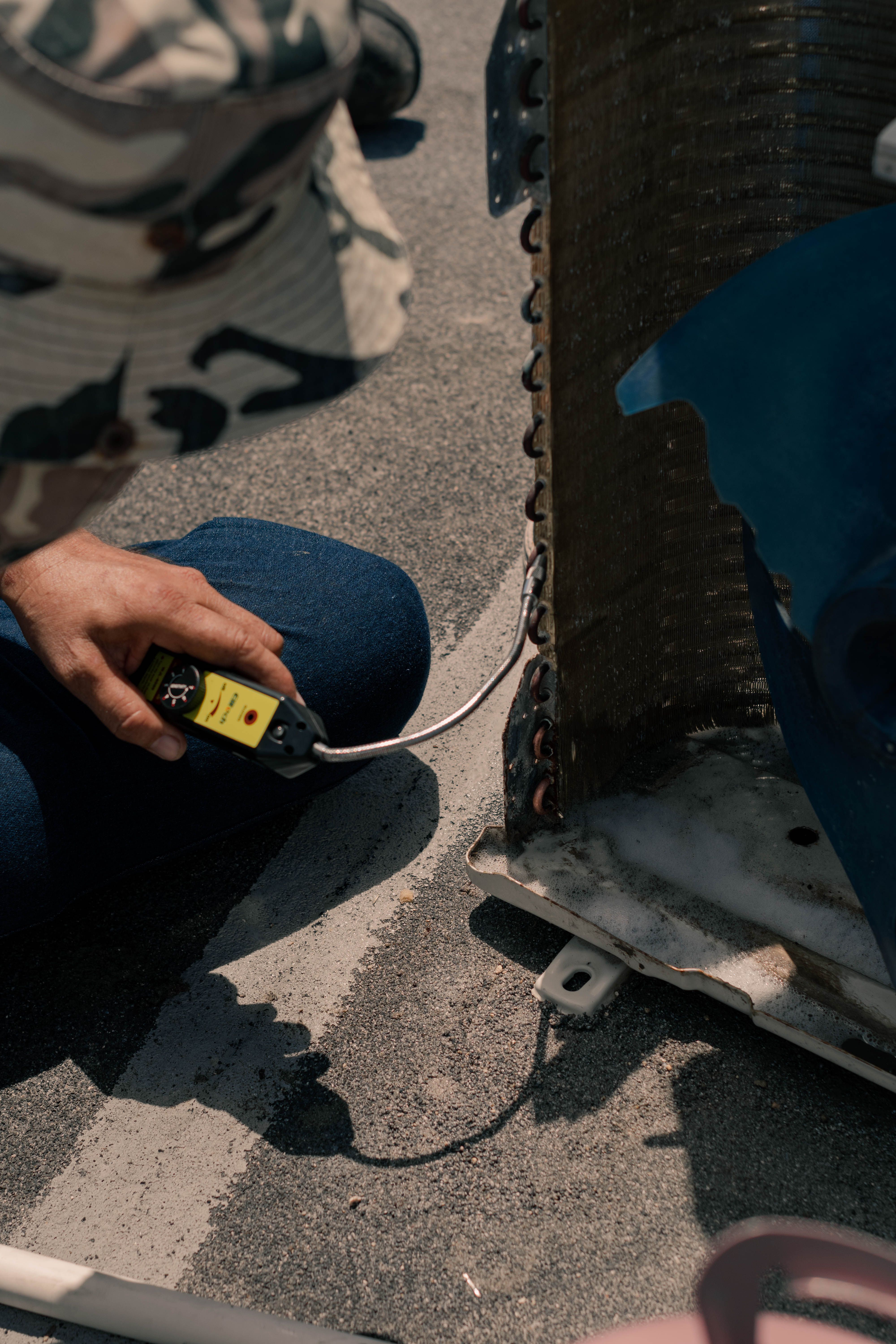 HVAC technician working with service tools outdoors