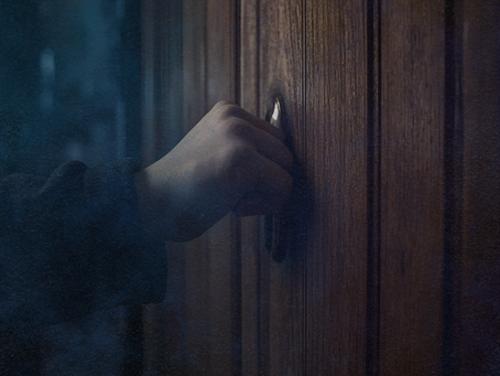eerie hand knocking on a door at night