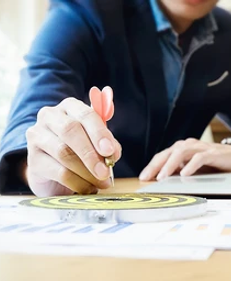 businessman-holding-darts-aiming-target-260nw-609308090.webp