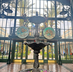 large atrium with 2 big pictures and a fountain