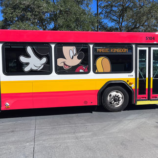 Disney World red and yellow bus with Mickey Mouse on the side