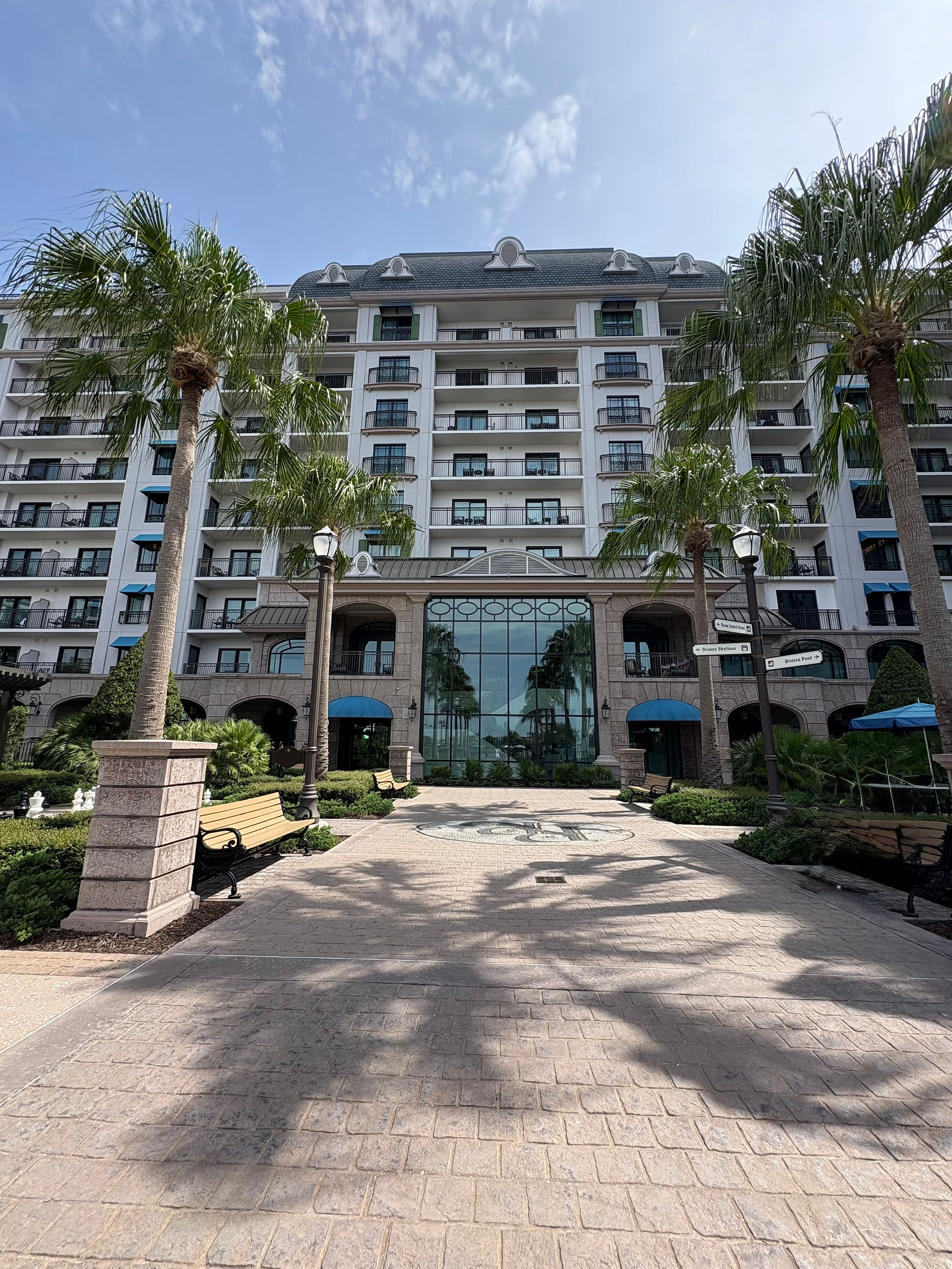Lush exterior of a resort with palm trees