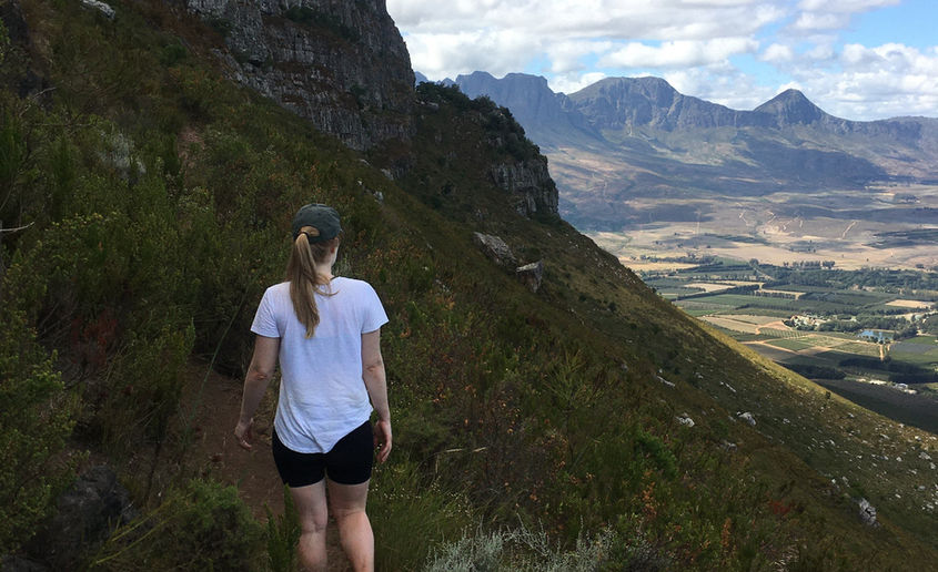 Female hiker in a white shirt.