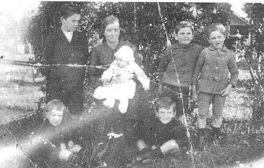 Woman with six children around her